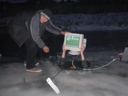 two slavic boys playing solitaire in the middle of the night on a crt monitor being held above a hole in the ice