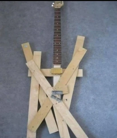 electric guitar with really badly put together body of wooden slabs jutting out every which way