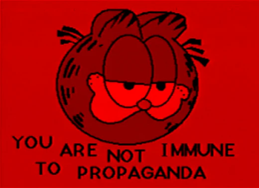 the text, “You are not immune to propaganda” under a crude drawing of Garfield’s smug face