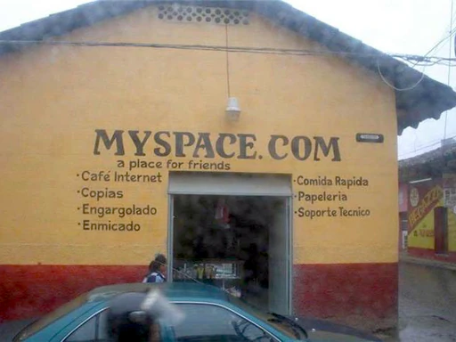 Picture of an abode hut that is an internet cafe titled, “myspace.com,” in a third world Spanish-speaking country