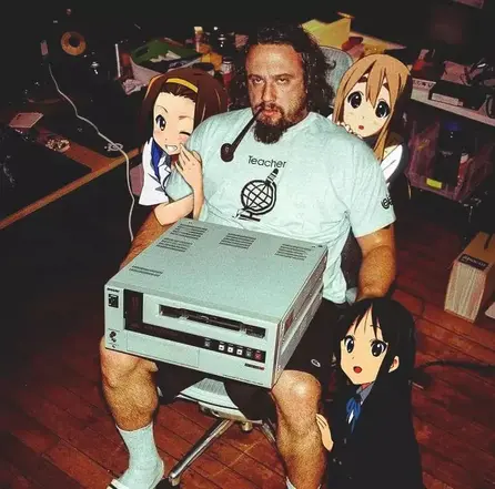 Sam Hyde with huge computer and photoshopped anime girls surrounding him