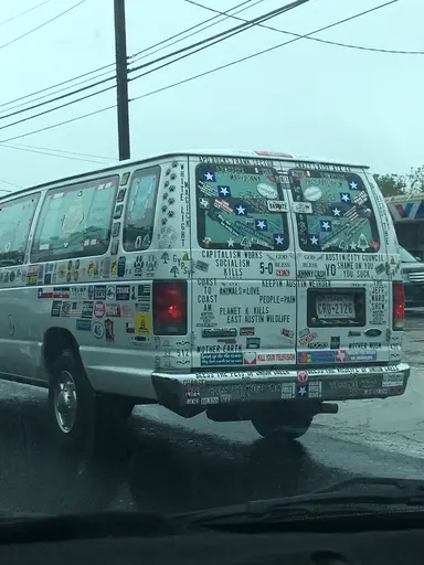 white van with about 100 different political and religious stickers