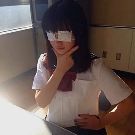 japanese middle schooler sitting at desk wearing two eyepatches over both eyes and striking a chuunibyou pose